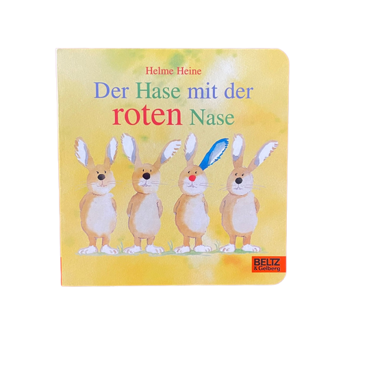 Osterbuch mit vier Hasen und einem blauen Hasenohr.